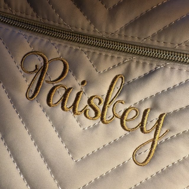 Custom embroidered name on a quilted bag