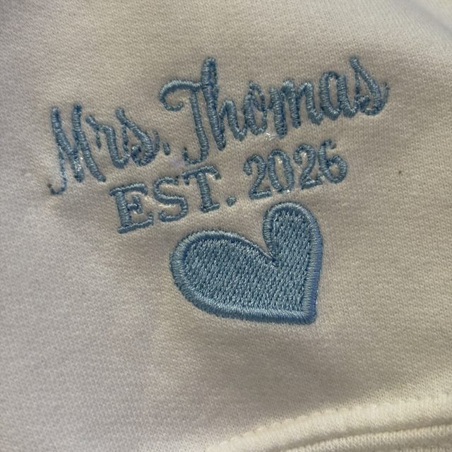 Custom embroidered name and date detail on a sleeve