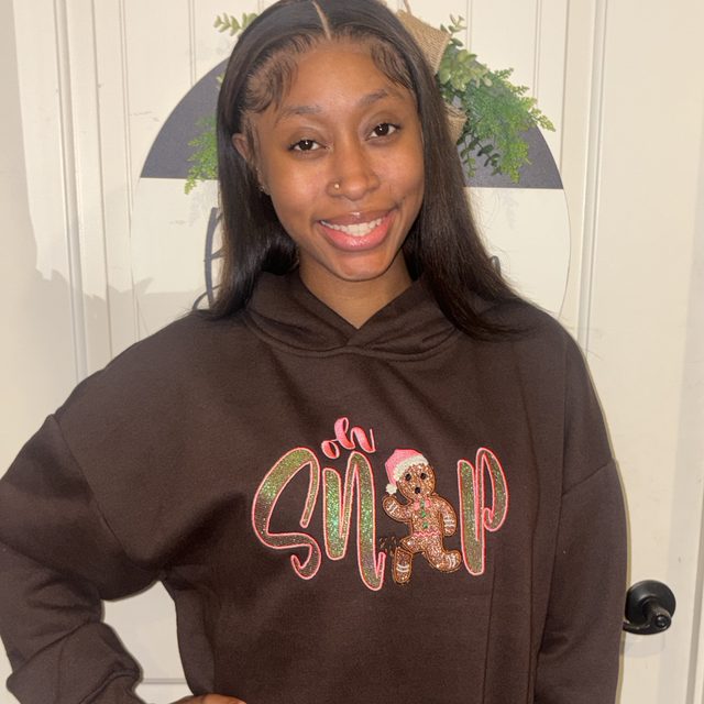 Customer wearing a custom embroidered holiday hoodie